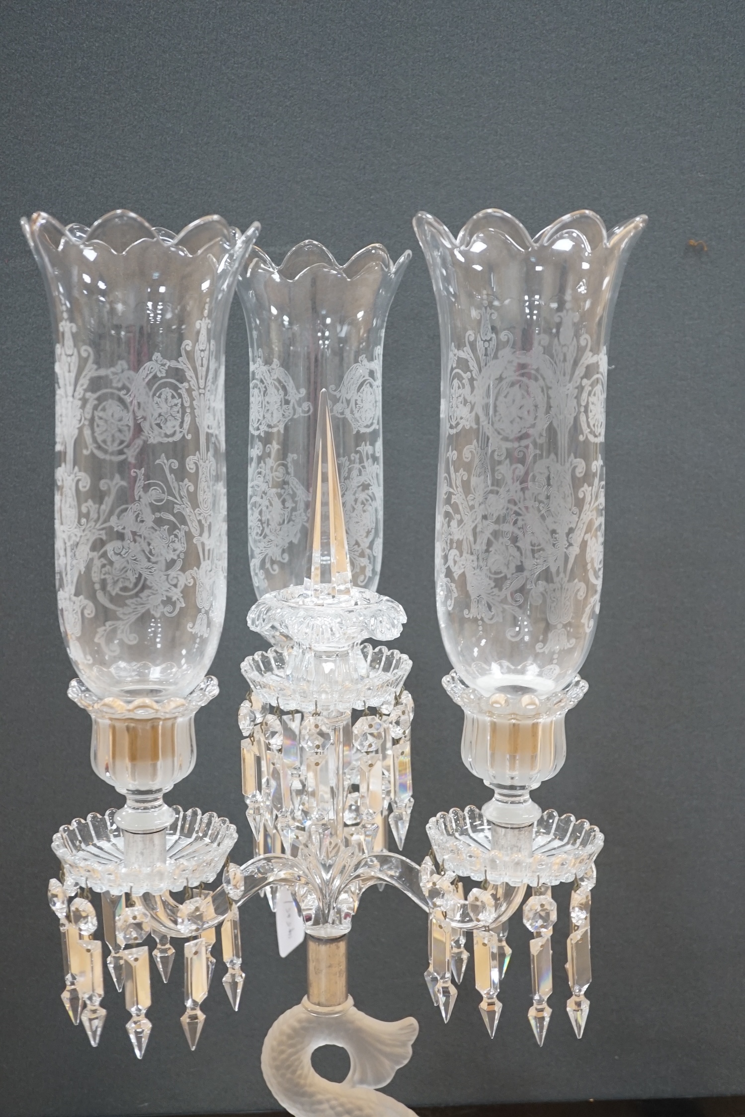 A Baccarat three branch, fish stemmed glass candelabra, 68cm high